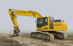 What Is an Excavator? Key Facts, Popular Models, and Buying Tips 1 Yellow Crawler Excavator in fog