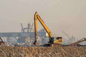 What Is an Excavator? Key Facts, Popular Models, and Buying Tips 4 Yellow Long Reach Excavator in Smog