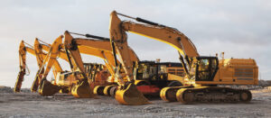 Row of yellow excavators lined up