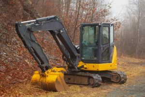 What Is an Excavator? Key Facts, Popular Models, and Buying Tips 3 yellow mini excavator in fog