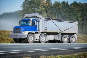 Blue dump truck parked on road