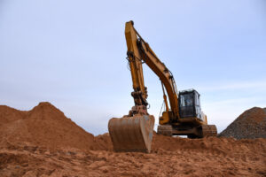 Excavator Types and Uses: Full Breakdown for Contractors 1 Yellow Crawler Excavator in red cay mud