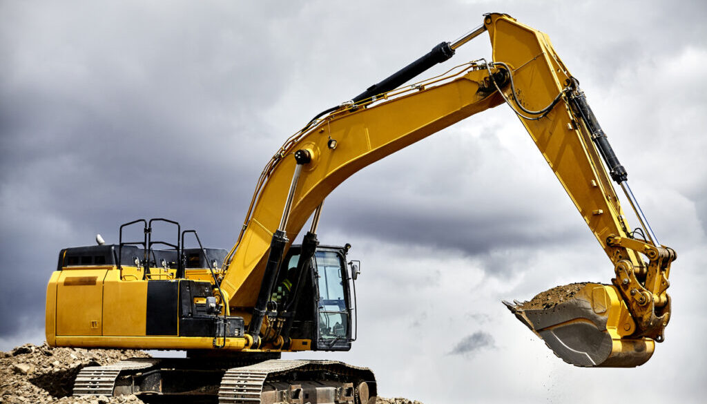 yellow crawler excavator in cloudy sky