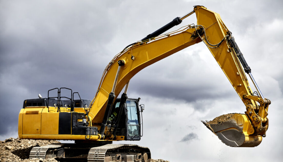 yellow crawler excavator in cloudy sky