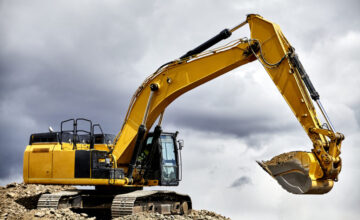 yellow crawler excavator in cloudy sky