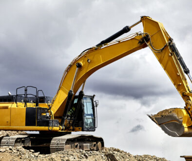yellow crawler excavator in cloudy sky