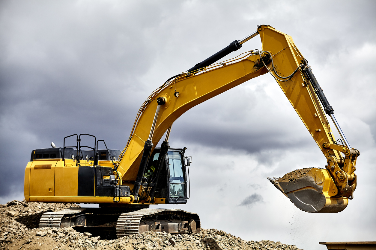 yellow crawler excavator in cloudy sky