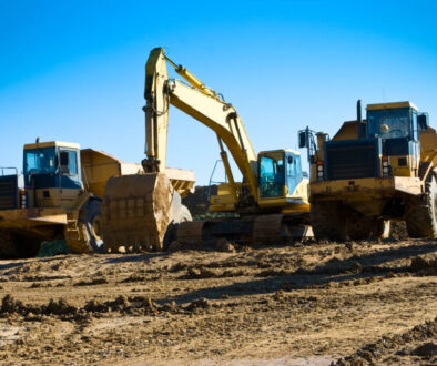 Construction vehicles on a dirt site. DOT safety regulations