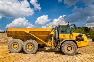 Yellow articulated dump truck on construction site