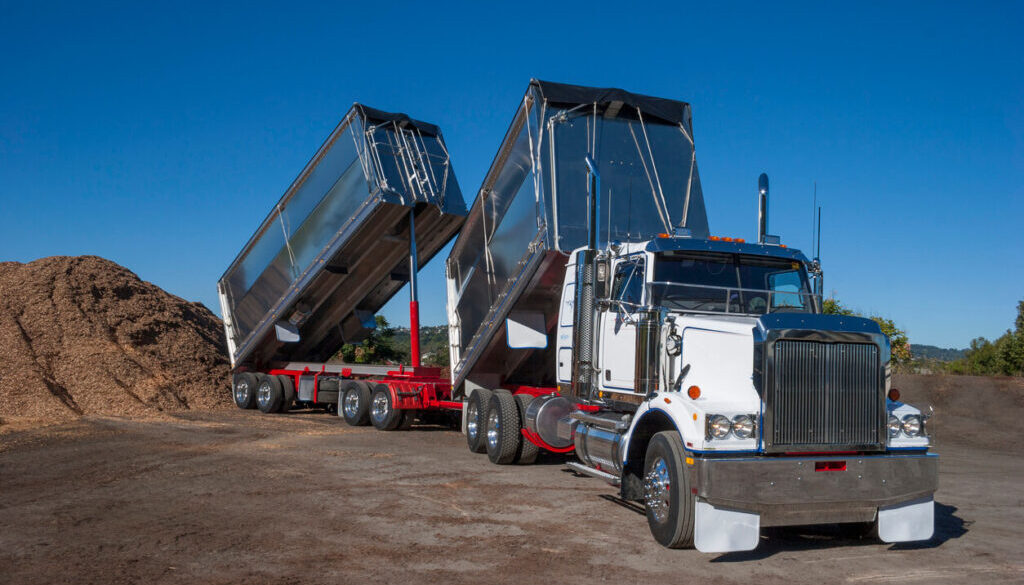 Dump truck unloading materials outdoors
