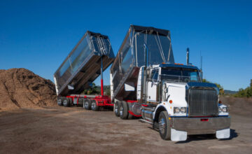 Dump truck unloading materials outdoors