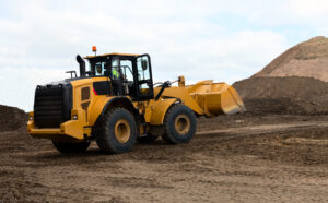 Yellow construction vehicle on dirt site
