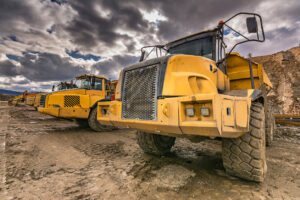 Yellow dump trucks on construction site