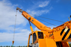 Top 22 Construction Equipment Types for Contractors 9 Orange crane against blue sky