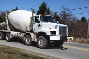 Concrete Trucks in Construction: Types Uses and Costs 2 White concrete mixer truck on road