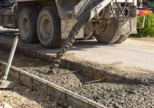 Concrete Trucks in Construction: Types Uses and Costs 1 Concrete trucks pouring fresh cement