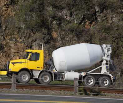 Yellow concrete mixer truck on road