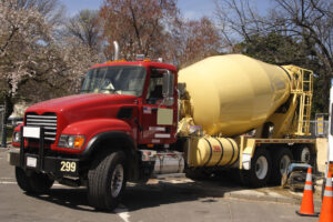 Red and yellow concrete mixer truck