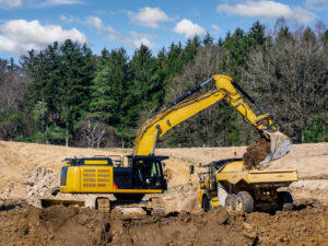 Excavator loading dirt into truck