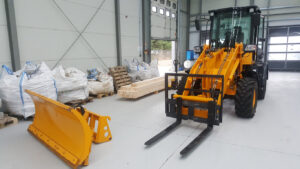 Top 5 Skid Steer Attachments for Contractors in 2026 1 Skid steer with attachments in warehouse